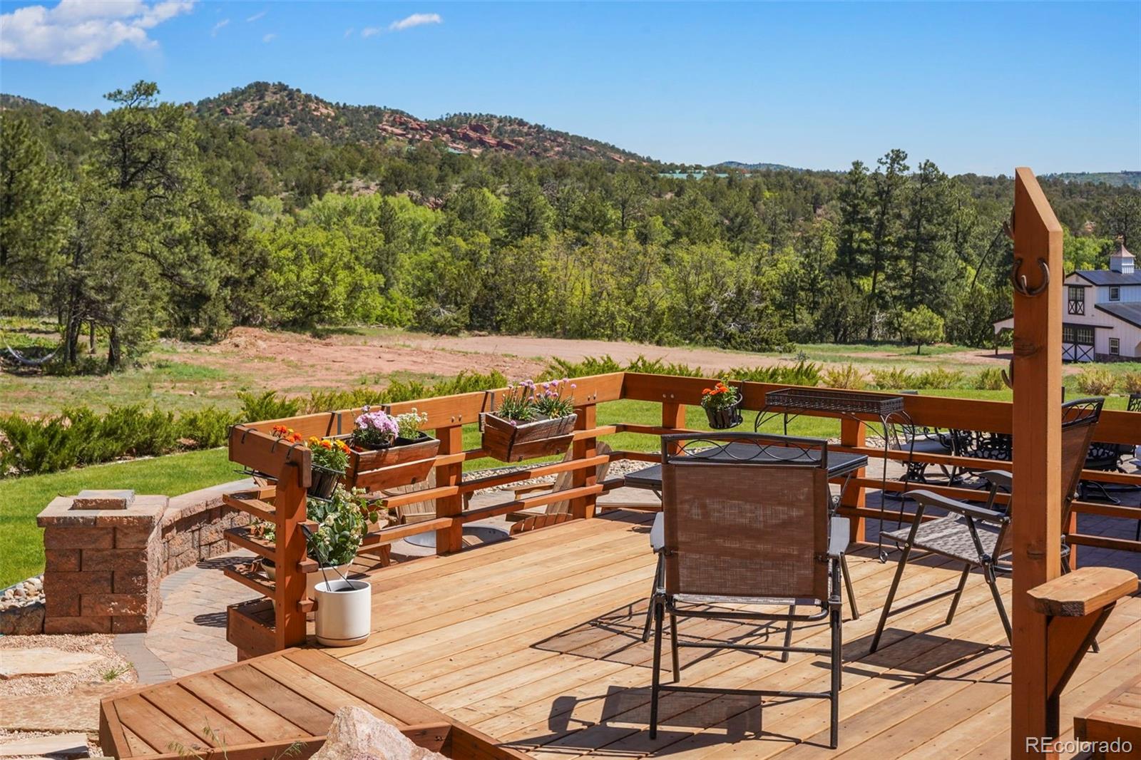15010 Henry Ride Heights Colorado Springs, CO 80926 - Photo 29 of 50 a view of a chairs and table on the terrace