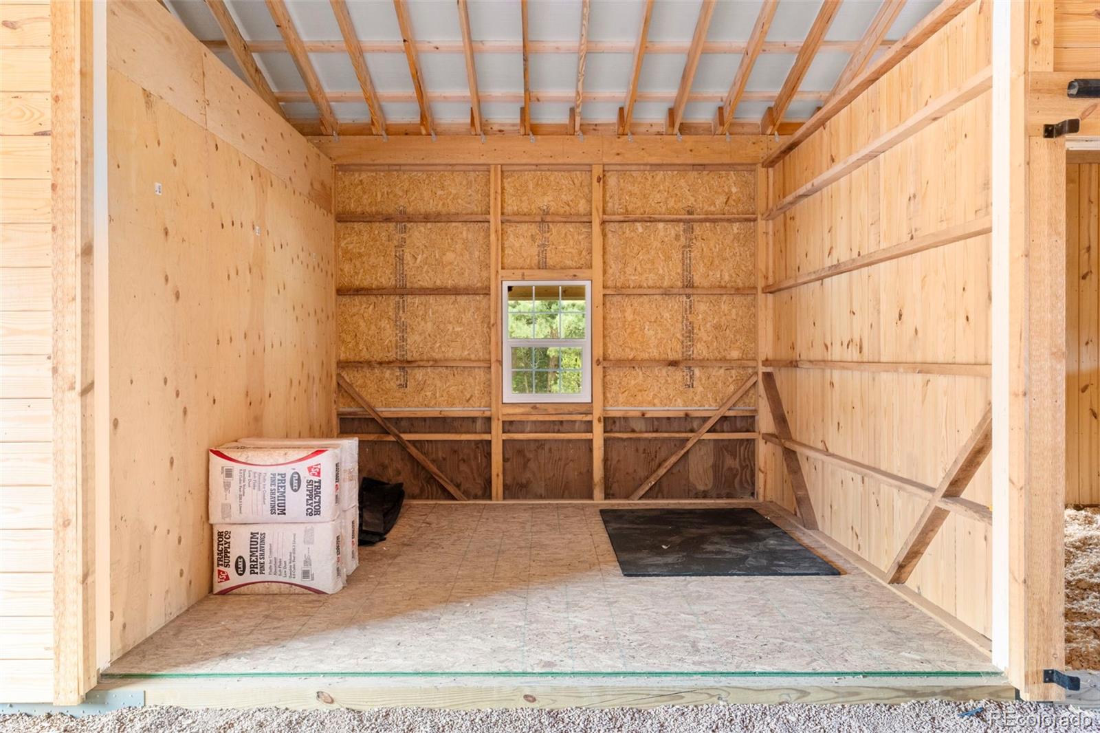 15010 Henry Ride Heights Colorado Springs, CO 80926 - Photo 39 of 50 a living room with a couch and a table with wooden floor