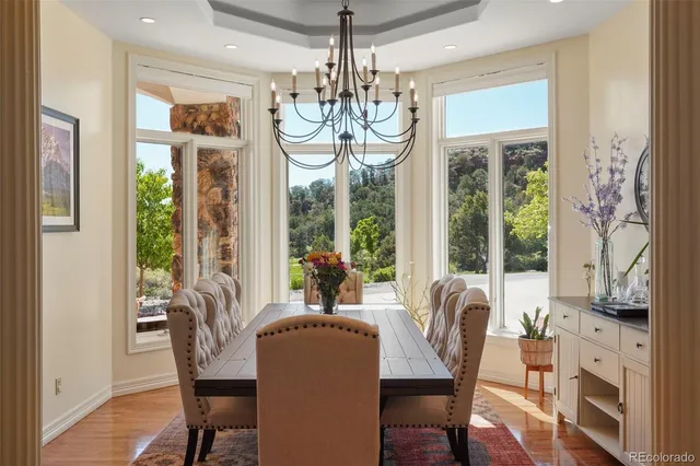 a view of a dining room with furniture wooden floor and chandelier