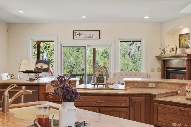 a kitchen with sink refrigerator and large window