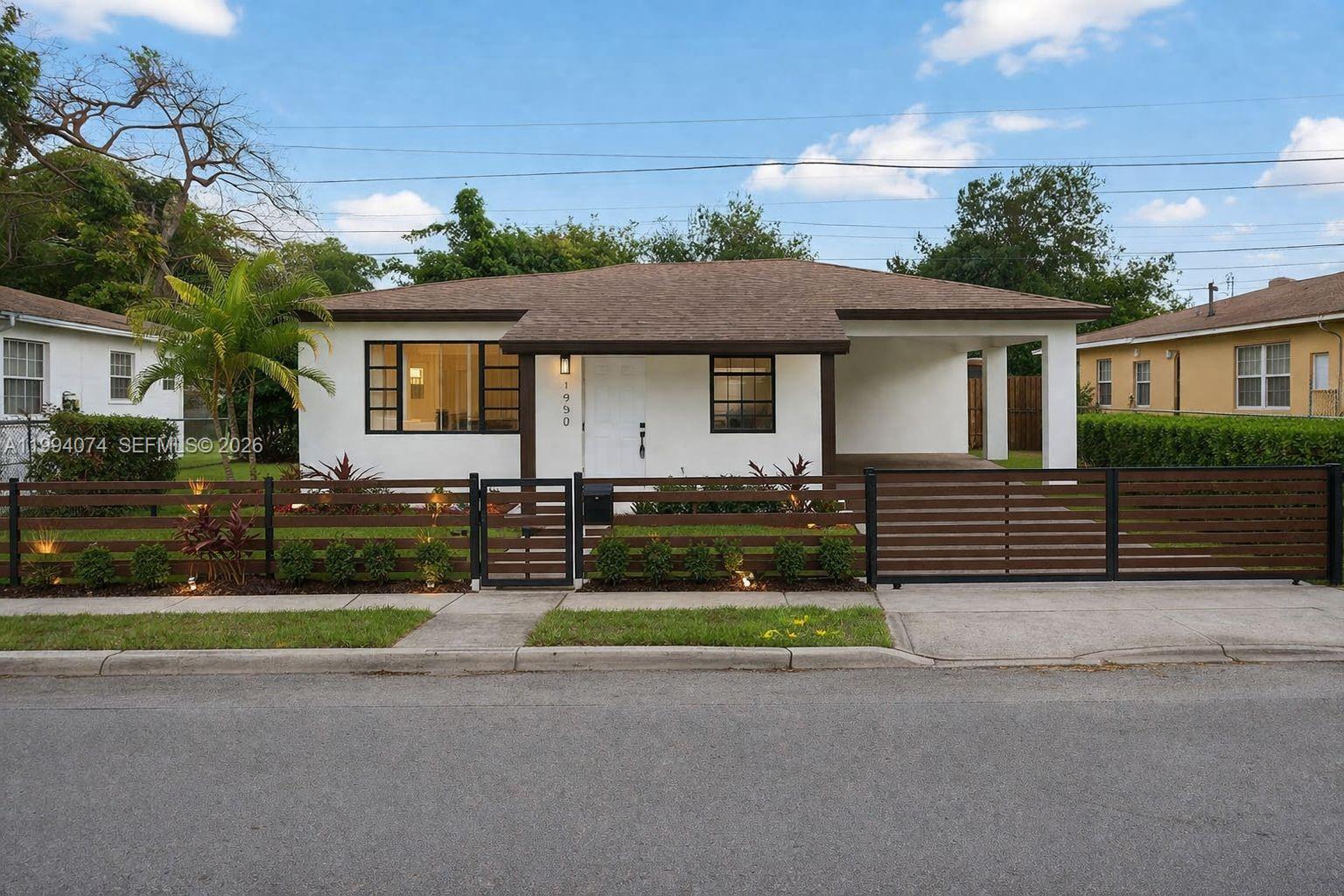 1950 Northwest 57th Street, Unit 1950 Miami, FL 33142 - Photo 1 of 10 a front view of a house with yard