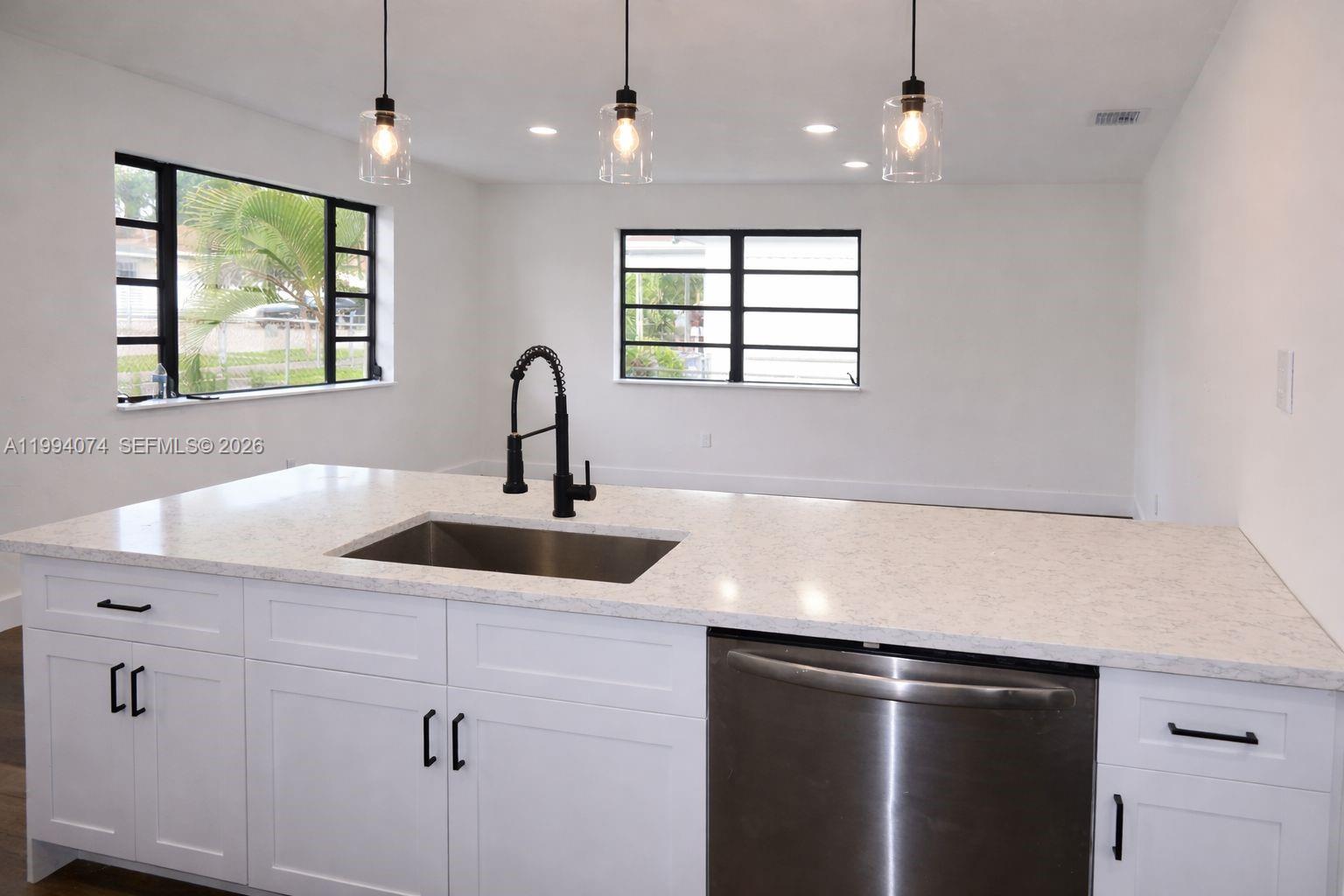 1950 Northwest 57th Street, Unit 1950 Miami, FL 33142 - Photo 4 of 10 a kitchen with stainless steel appliances a sink and a window