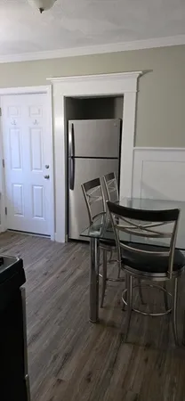 a room with a piano and wooden floors