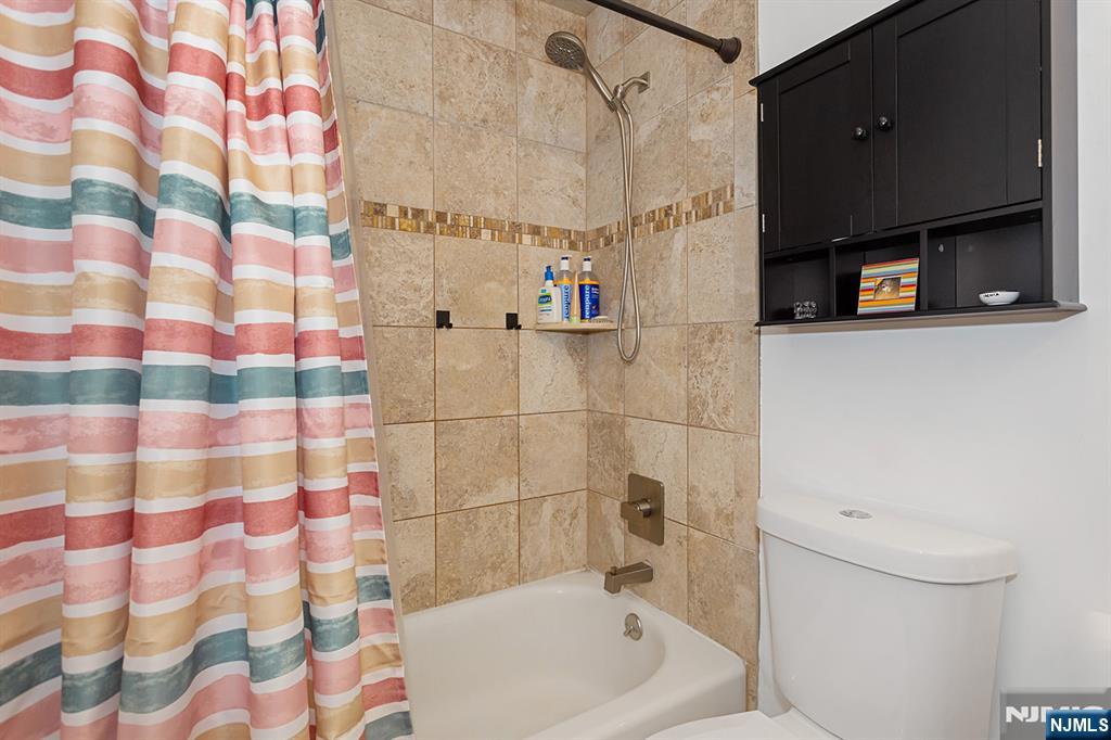 25 River Road, Unit B11 Nutley, NJ 07110 - Photo 18 of 30 a bathroom with a bathtub and a shower