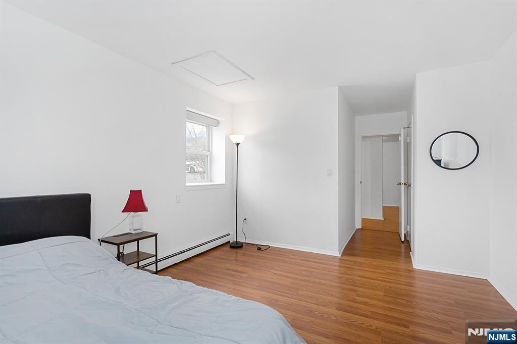 25 River Road, Unit B11 Nutley, NJ 07110 - Photo 22 of 30 a bedroom with wooden floor and closet