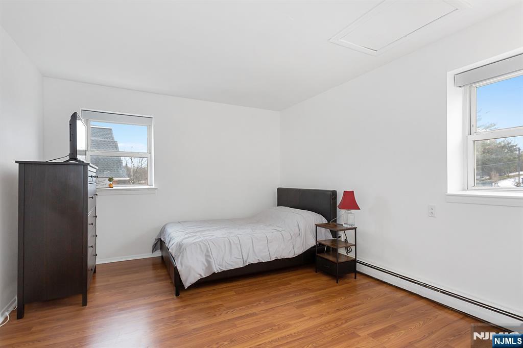 25 River Road, Unit B11 Nutley, NJ 07110 - Photo 23 of 30 a bedroom with a bed and wooden floor