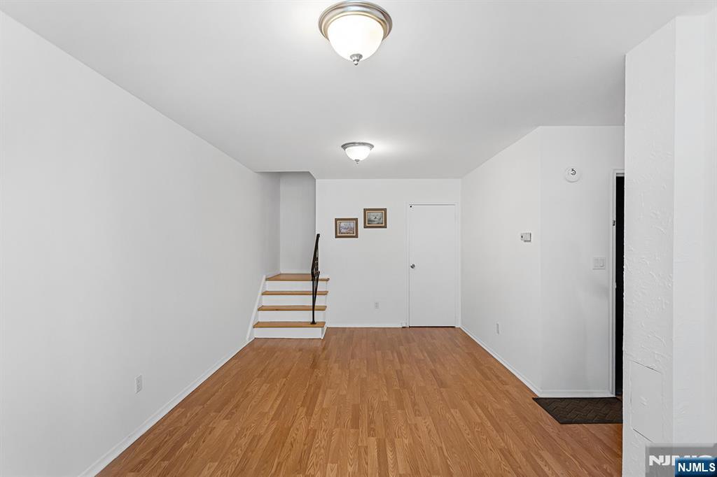 25 River Road, Unit B11 Nutley, NJ 07110 - Photo 25 of 30 a view of a room with wooden floor and white walls