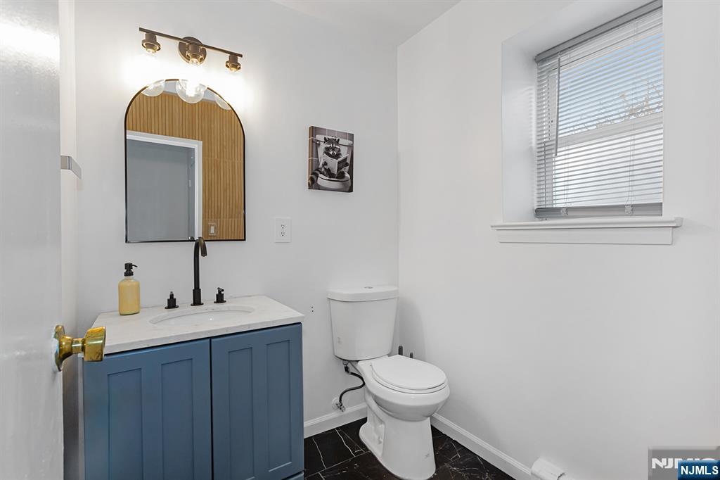 25 River Road, Unit B11 Nutley, NJ 07110 - Photo 26 of 30 a bathroom with a toilet sink and mirror