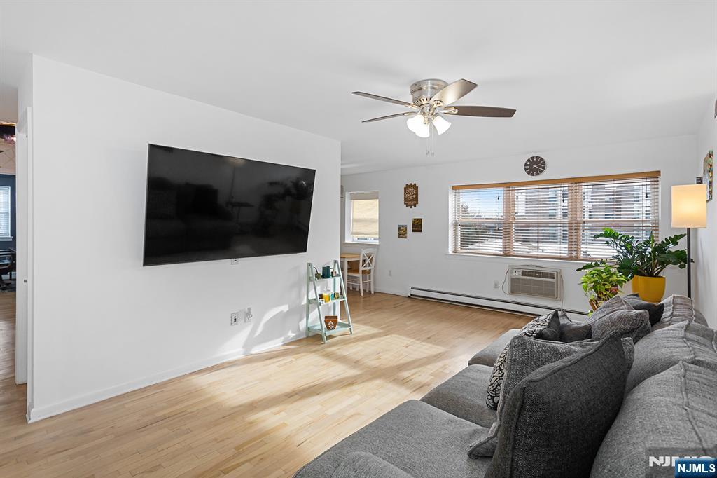 25 River Road, Unit B11 Nutley, NJ 07110 - Photo 3 of 30 a living room with furniture a flat screen tv and a window