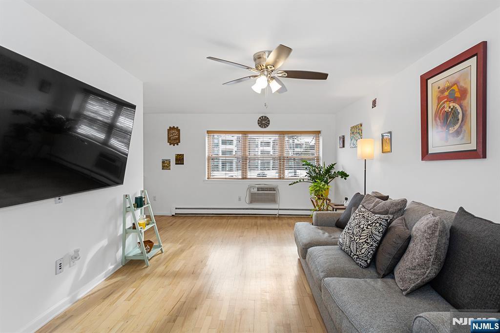 25 River Road, Unit B11 Nutley, NJ 07110 - Photo 4 of 30 a living room with furniture and a flat screen tv
