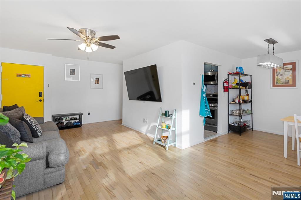 25 River Road, Unit B11 Nutley, NJ 07110 - Photo 5 of 30 a view of a livingroom with furniture and a flat screen tv
