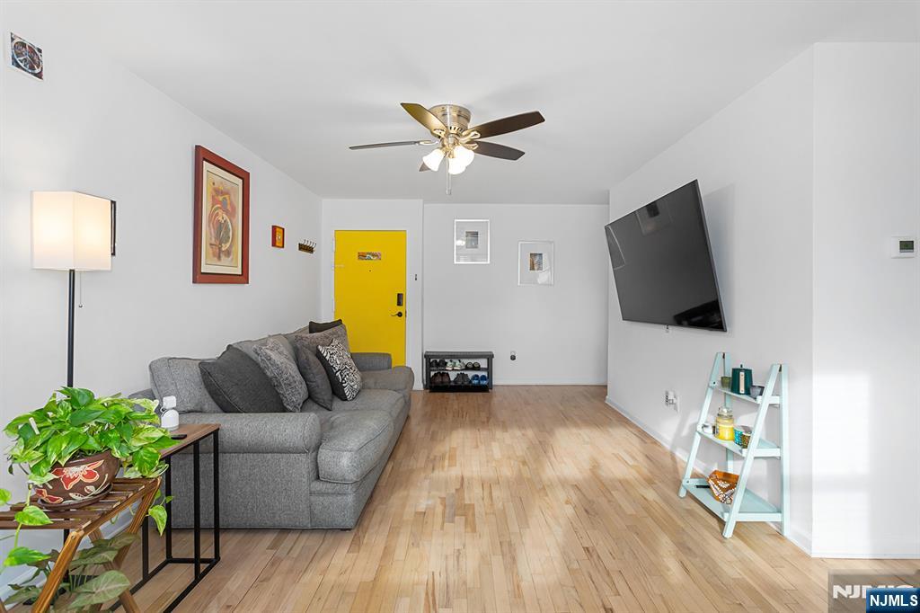 25 River Road, Unit B11 Nutley, NJ 07110 - Photo 6 of 30 a living room with furniture and a flat screen tv