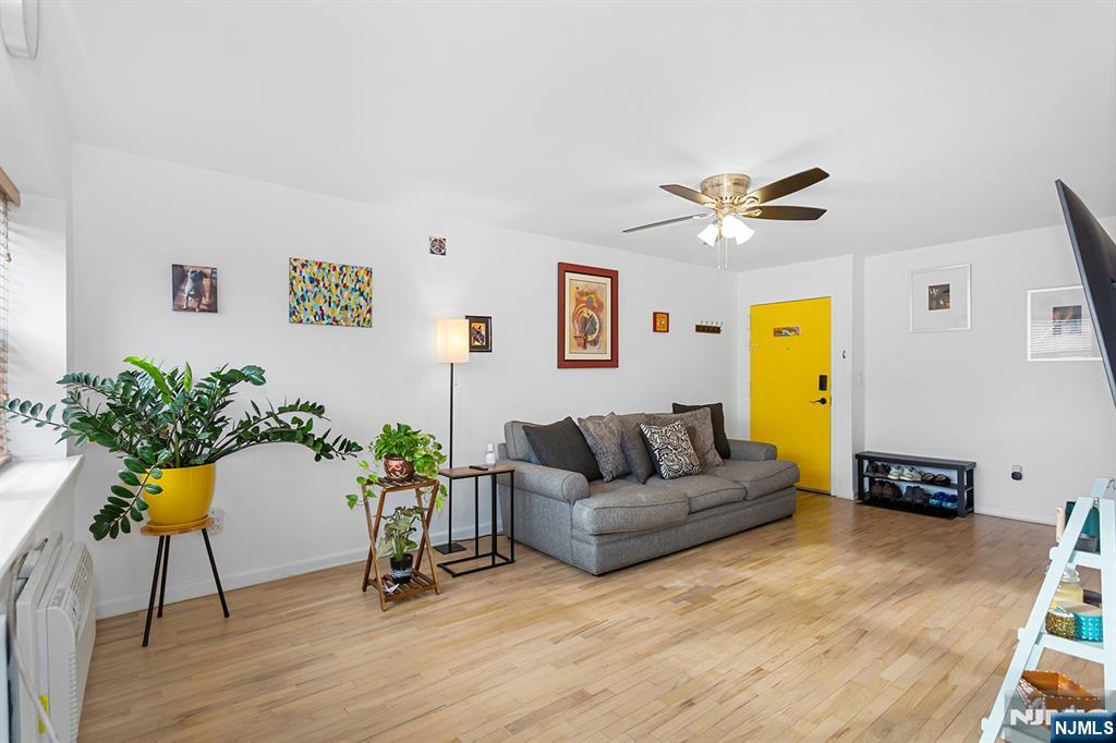 25 River Road, Unit B11 Nutley, NJ 07110 - Photo 7 of 30 a living room with furniture and wooden floor