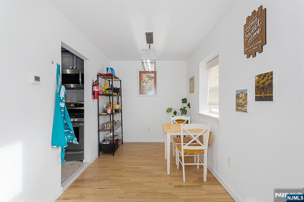 25 River Road, Unit B11 Nutley, NJ 07110 - Photo 8 of 30 a dining room with furniture and wooden floor