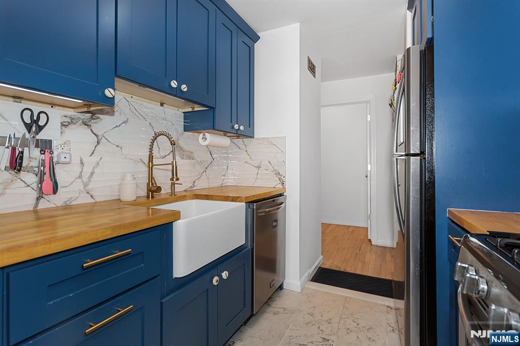 25 River Road, Unit B11 Nutley, NJ 07110 - Photo 10 of 30 a utility room with cabinets washer and dryer