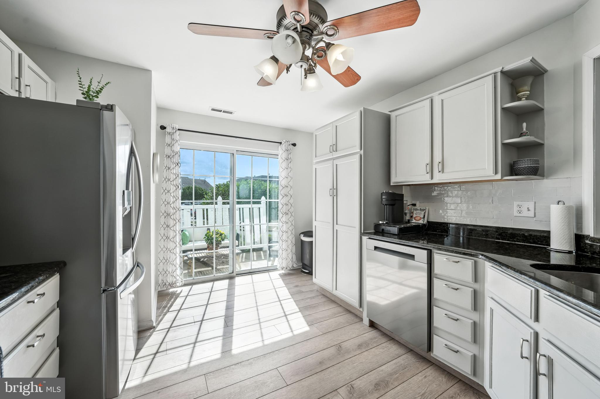 1501 Deborah Court, Unit 2102 Jamison, PA 18929 - Photo 3 of 21 a kitchen with stainless steel appliances granite countertop a stove a refrigerator a sink and white cabinets with wooden floor