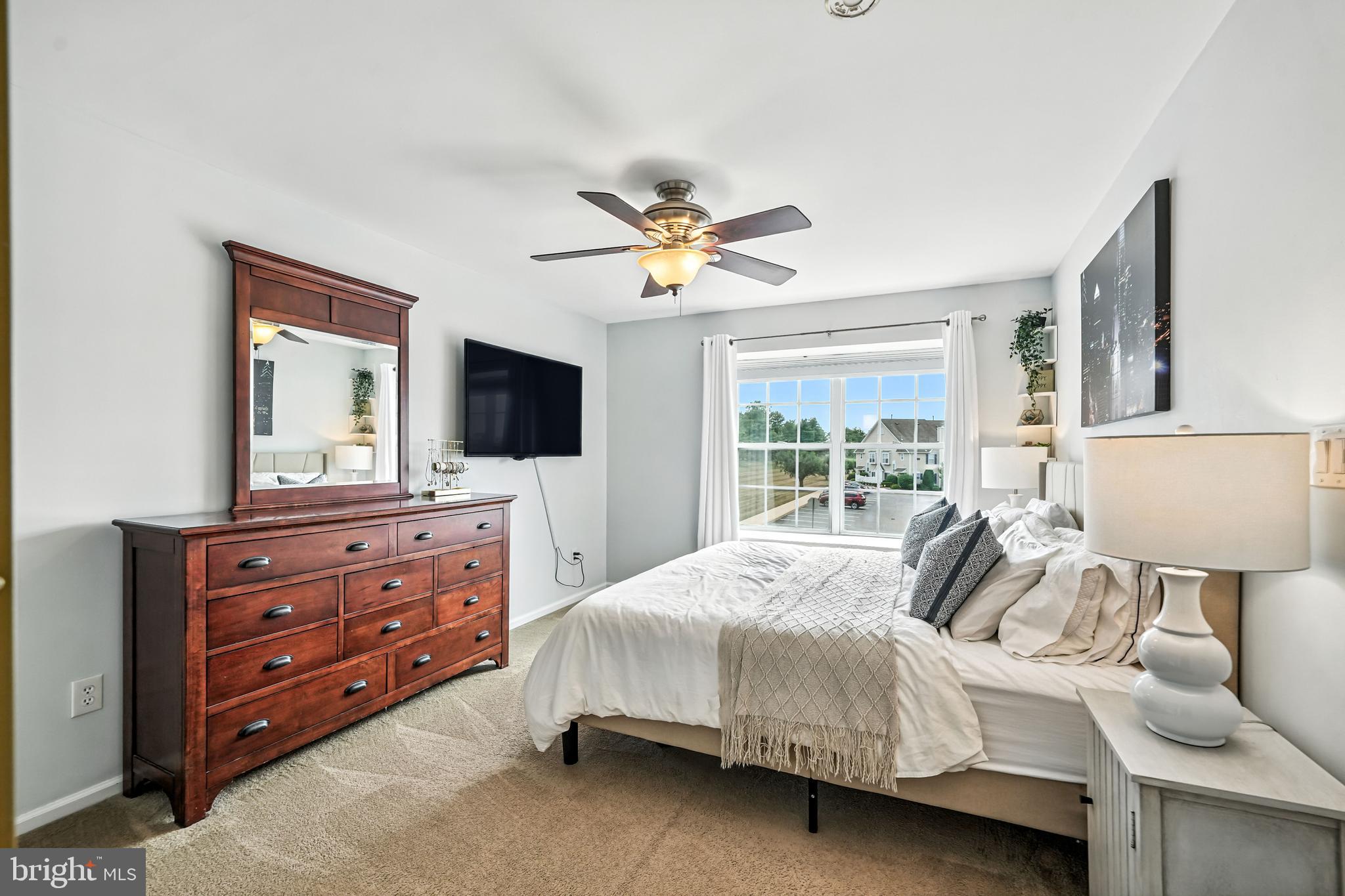 1501 Deborah Court, Unit 2102 Jamison, PA 18929 - Photo 9 of 21 a bedroom with a bed and a flat screen tv