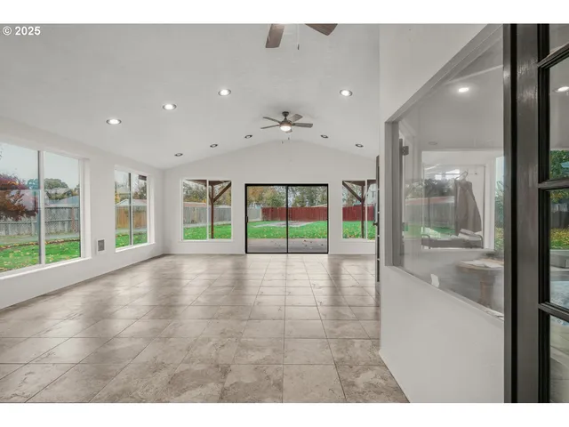 a view of an entryway with floor to ceiling window and wooden floor