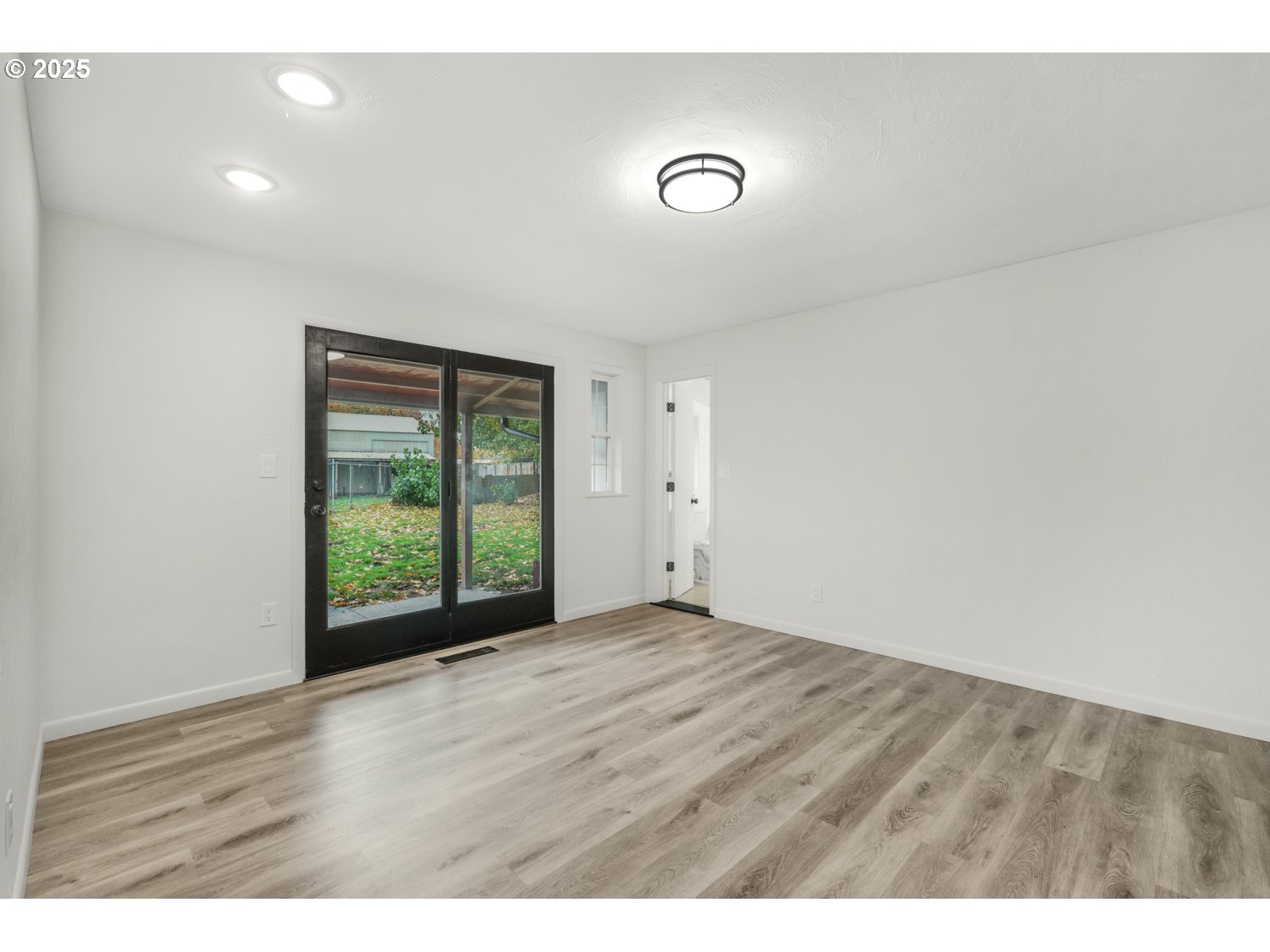 4160 Cordon Road Northeast Salem, OR 97305 - Photo 20 of 43 a view of an empty room with wooden floor and a window
