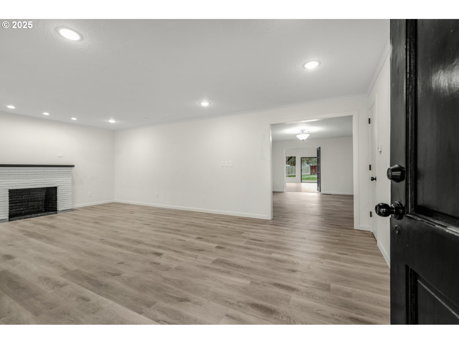 4160 Cordon Road Northeast Salem, OR 97305 - Photo 5 of 43 a view of an empty room with wooden floor and a fireplace