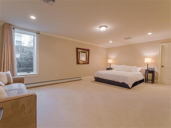 79 Pilgrim Road Wellesley, MA 02481 - Photo 29 of 30 a spacious bedroom with a bed and a couch