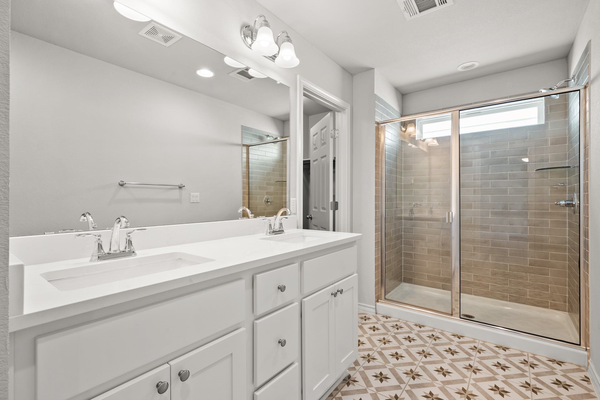 5107 Lemon Tree Path, Unit 127 Austin, TX 78723 - Photo 22 of 40 a bathroom with a double vanity sink mirror and shower