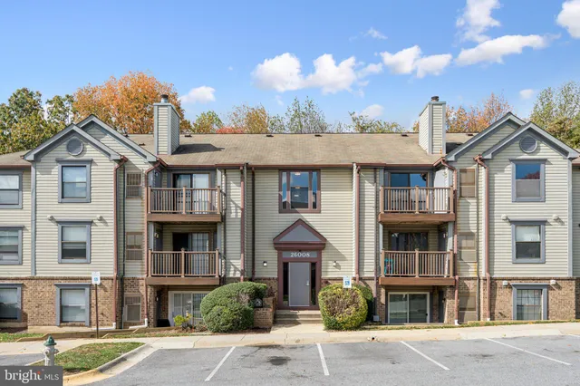 a front view of a residential apartment building with a yard