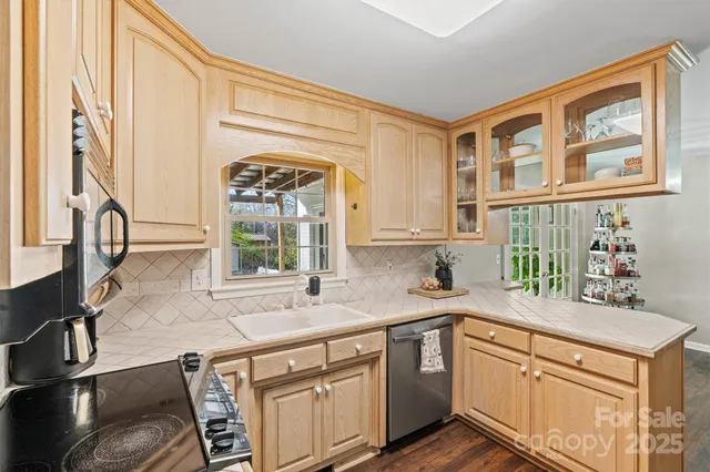 a kitchen with stainless steel appliances granite countertop a sink a stove and a microwave