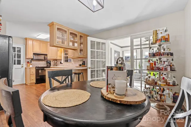 a dining room with furniture a rug and wooden floor