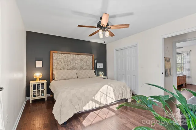a bedroom with a bed and wooden floor
