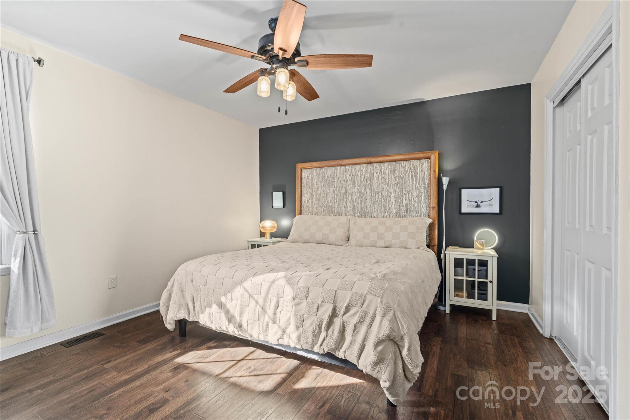 5645 Sandhurst Road Hickory, NC 28602 - Photo 18 of 46 a bedroom with a bed and a chandelier