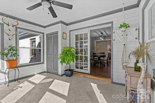 a living room with furniture and flowers