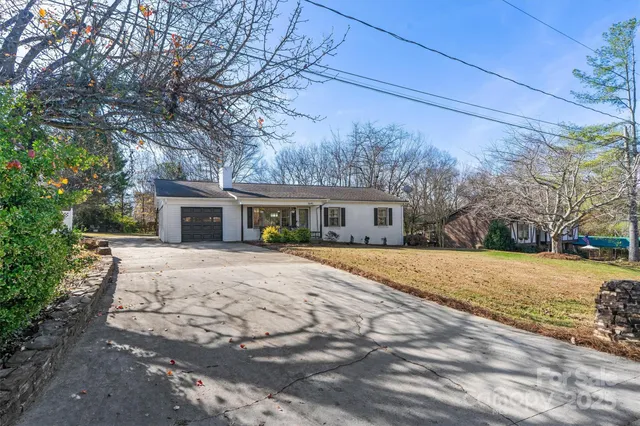 a front view of house with yard and trees