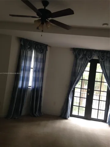 a view of an empty room and a window