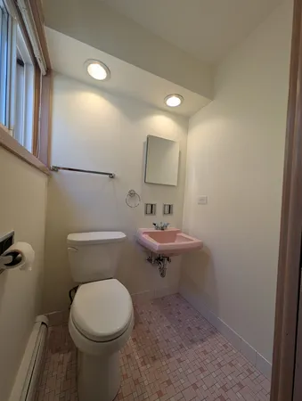 a bathroom with a sink a toilet and mirror