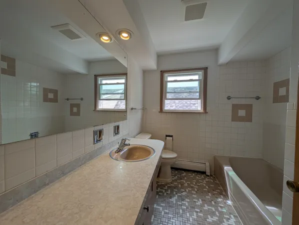 a bathroom with a sink a toilet and bathtub