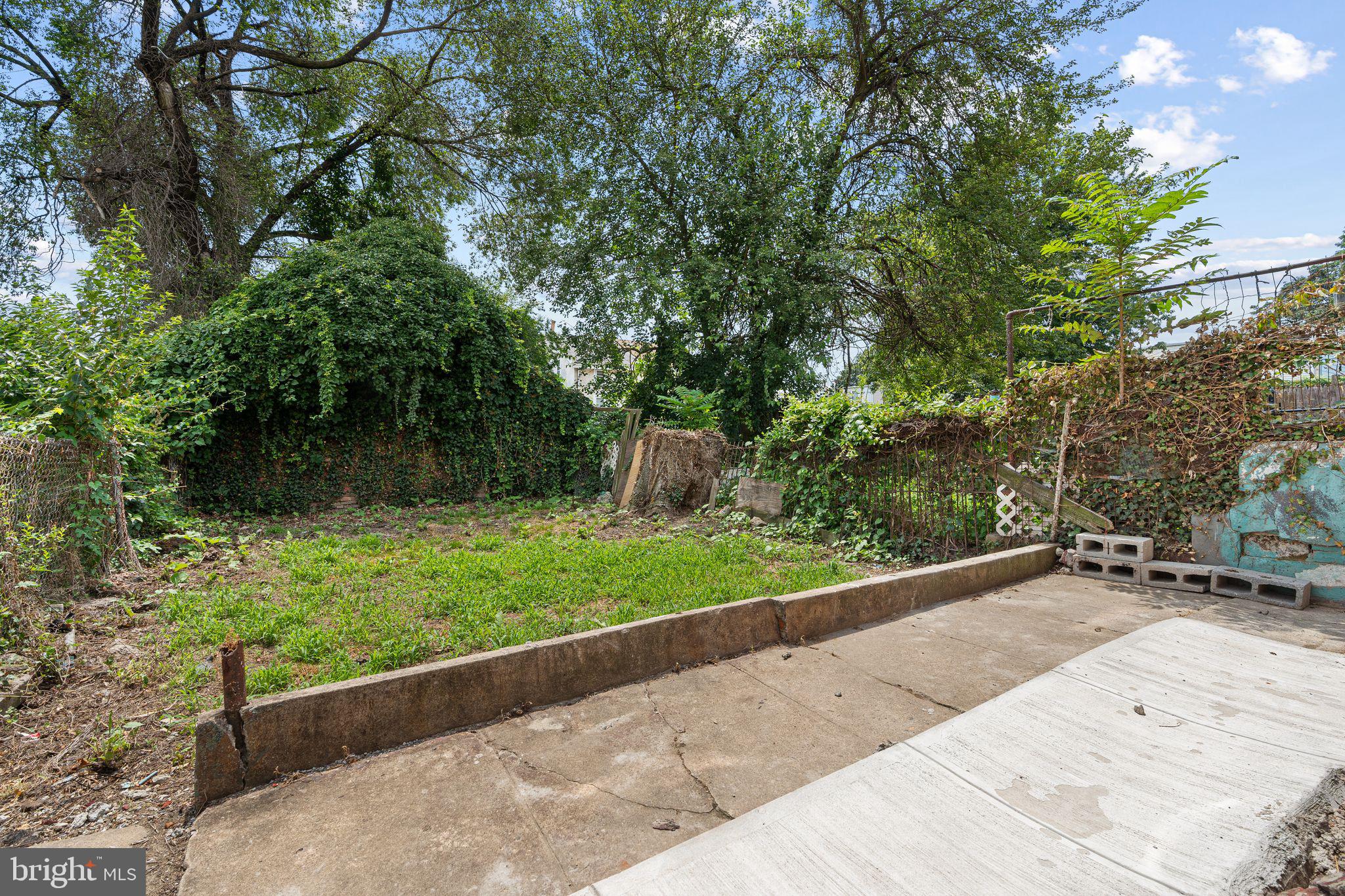 452 Mechanic Street Philadelphia, PA 19144 - Photo 26 of 32 a backyard of a house with lots of green space and fountain