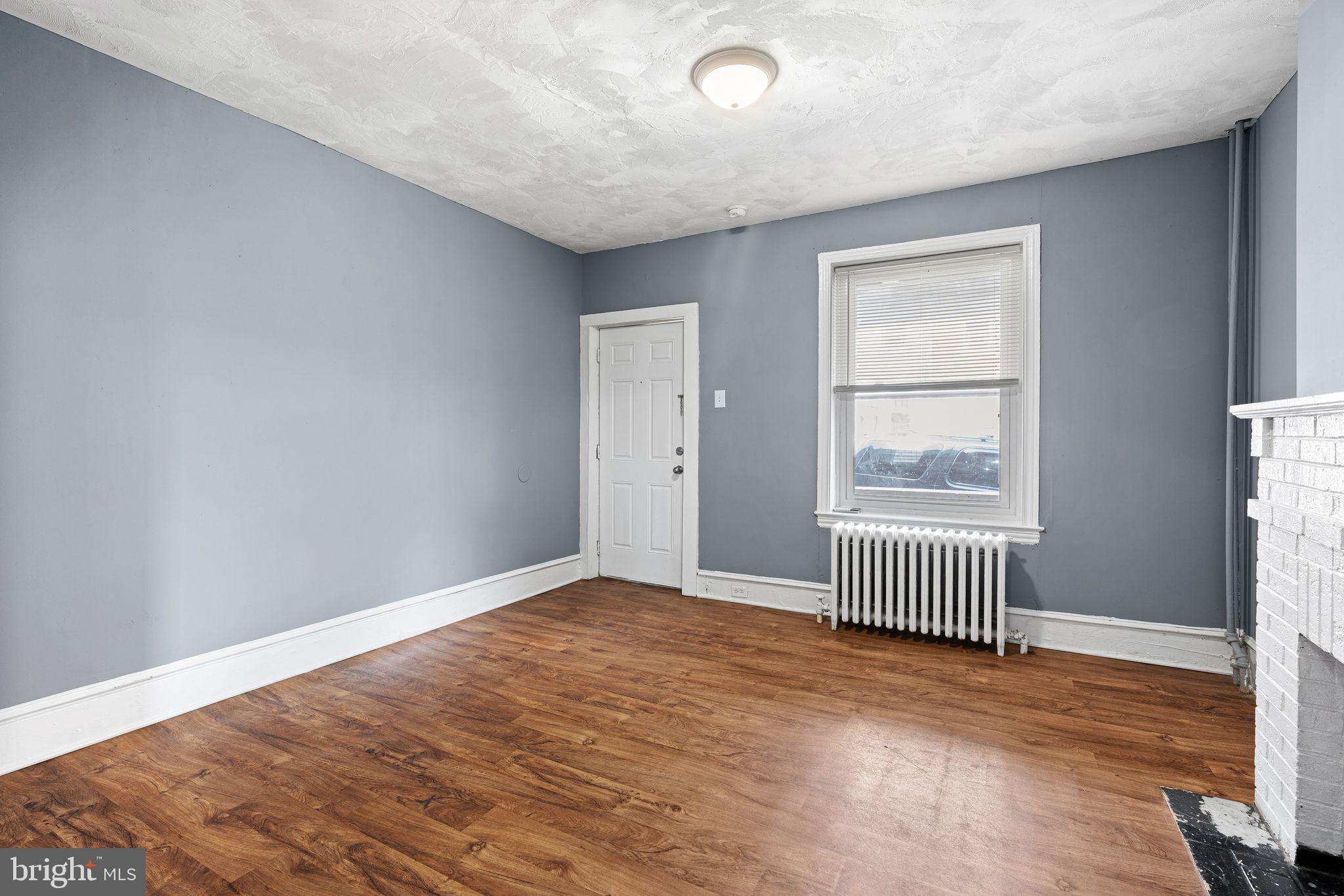 452 Mechanic Street Philadelphia, PA 19144 - Photo 4 of 32 an empty room with wooden floor and windows