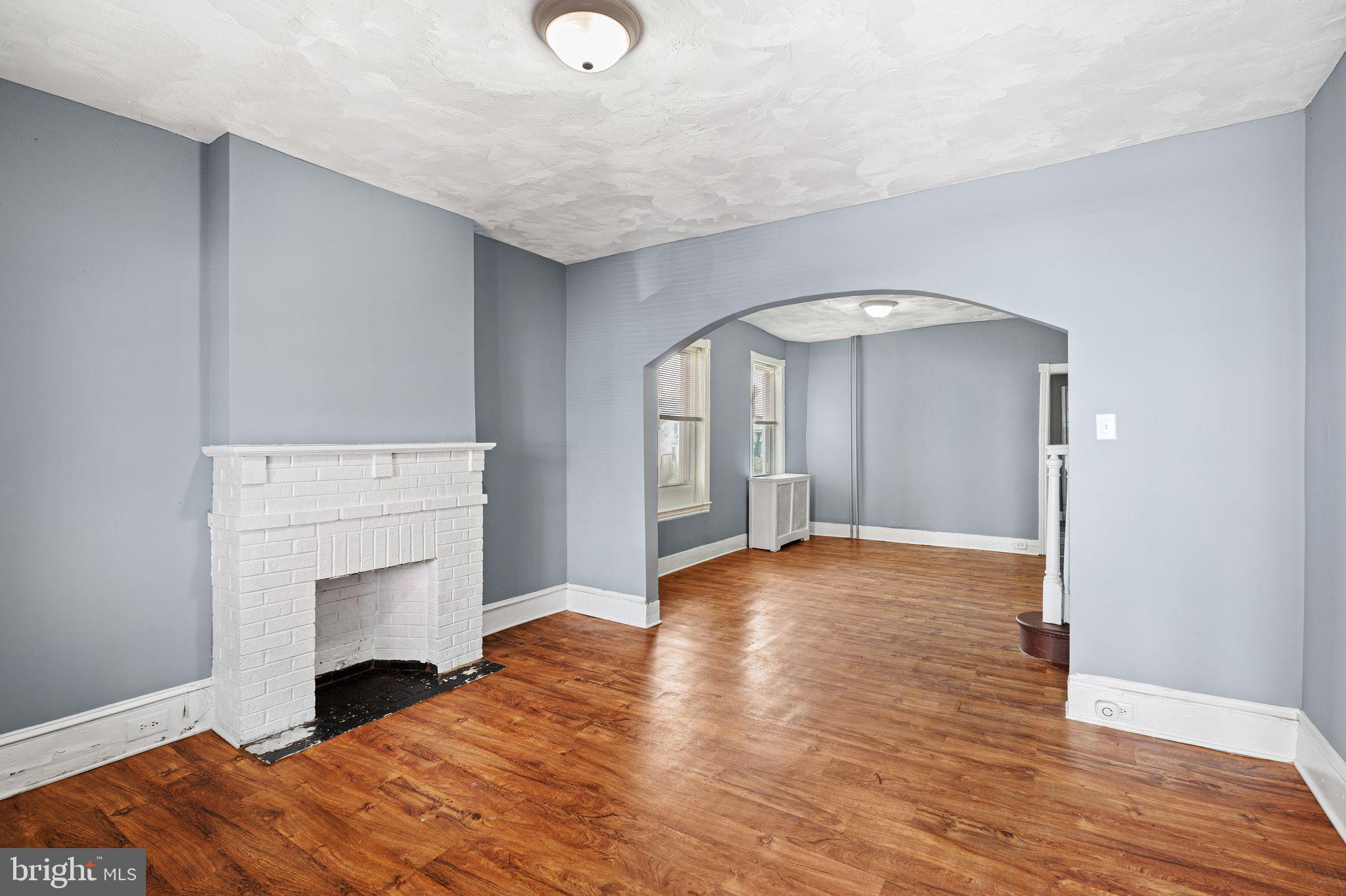 452 Mechanic Street Philadelphia, PA 19144 - Photo 5 of 32 a view of empty room with wooden floor and fireplace