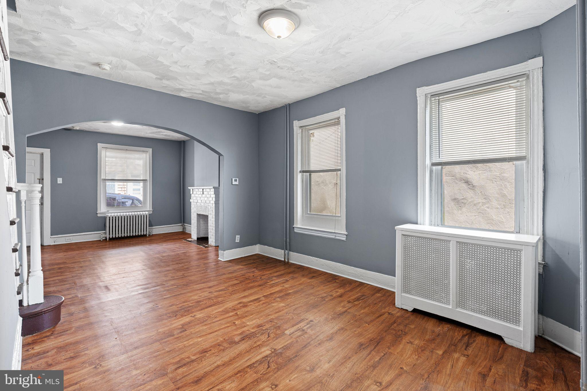 452 Mechanic Street Philadelphia, PA 19144 - Photo 6 of 32 an empty room with wooden floor and windows