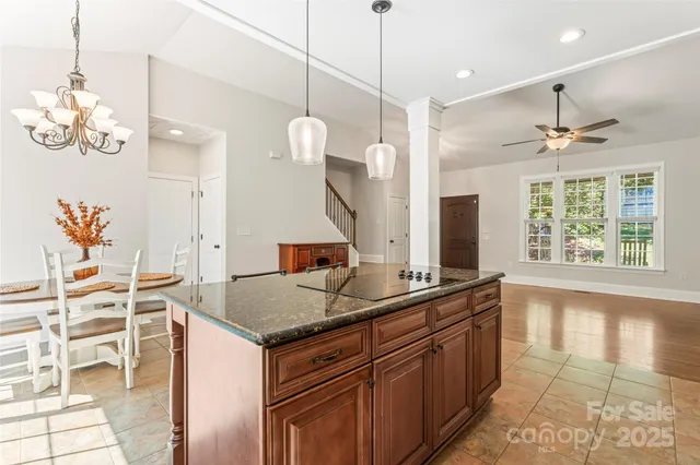 a kitchen with granite countertop a sink and chandelier