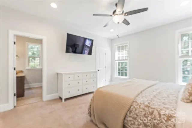 a spacious bedroom with a bed and a window