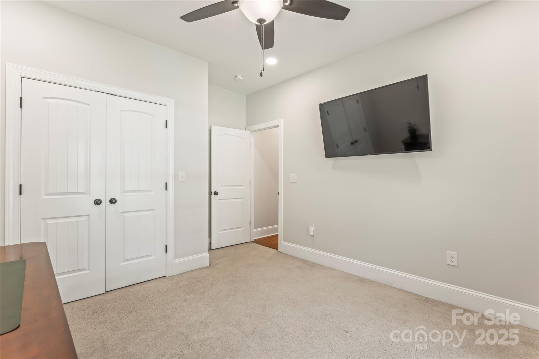 2775 Beechwood Road Denver, NC 28037 - Photo 21 of 33 a view of an empty room with wooden floor and a ceiling fan