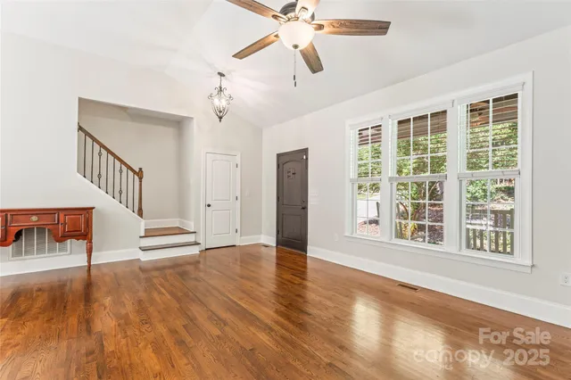a view of an entryway with wooden floor and a ceiling fan
