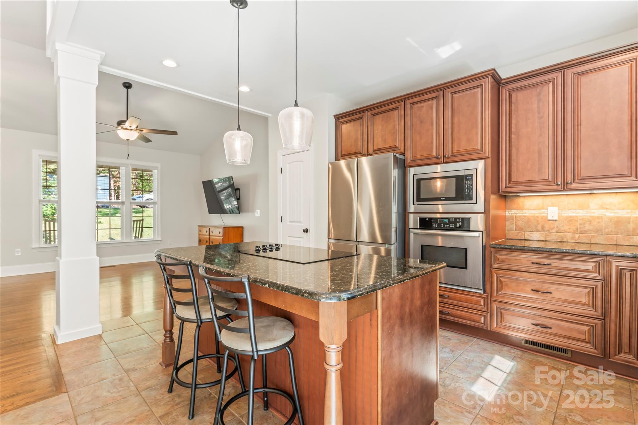 2775 Beechwood Road Denver, NC 28037 - Photo 10 of 33 a kitchen with stainless steel appliances kitchen island granite countertop a refrigerator and microwave