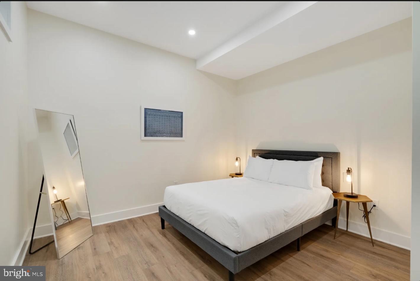 150 South Independence Mall West, Unit 1013 Philadelphia, PA 19106 - Photo 15 of 16 a bedroom with a bed and wooden floor