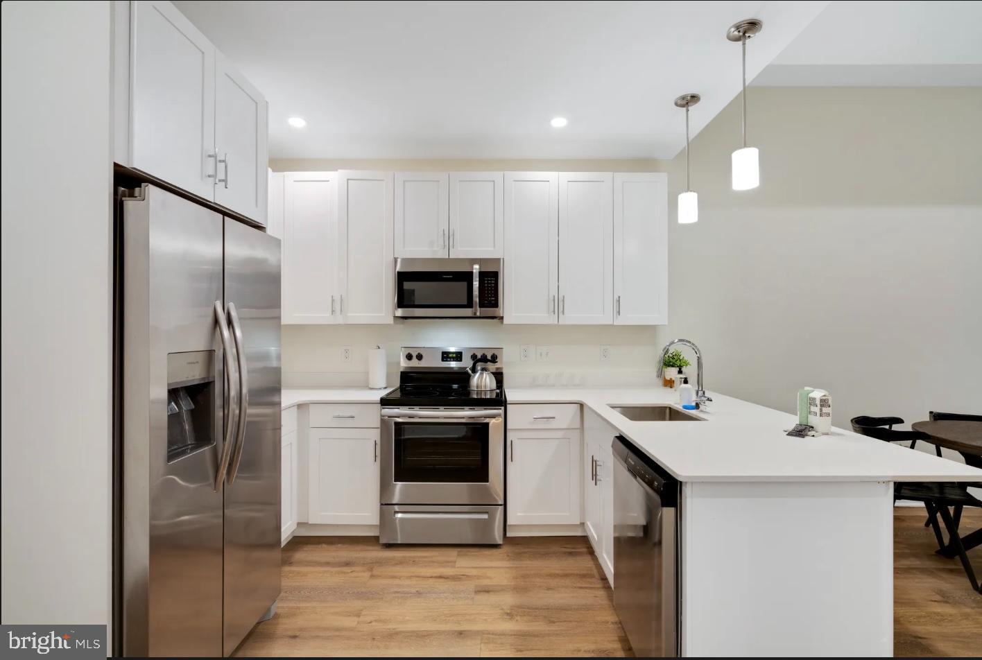 150 South Independence Mall West, Unit 1013 Philadelphia, PA 19106 - Photo 6 of 16 a kitchen with a sink stainless steel appliances and cabinets