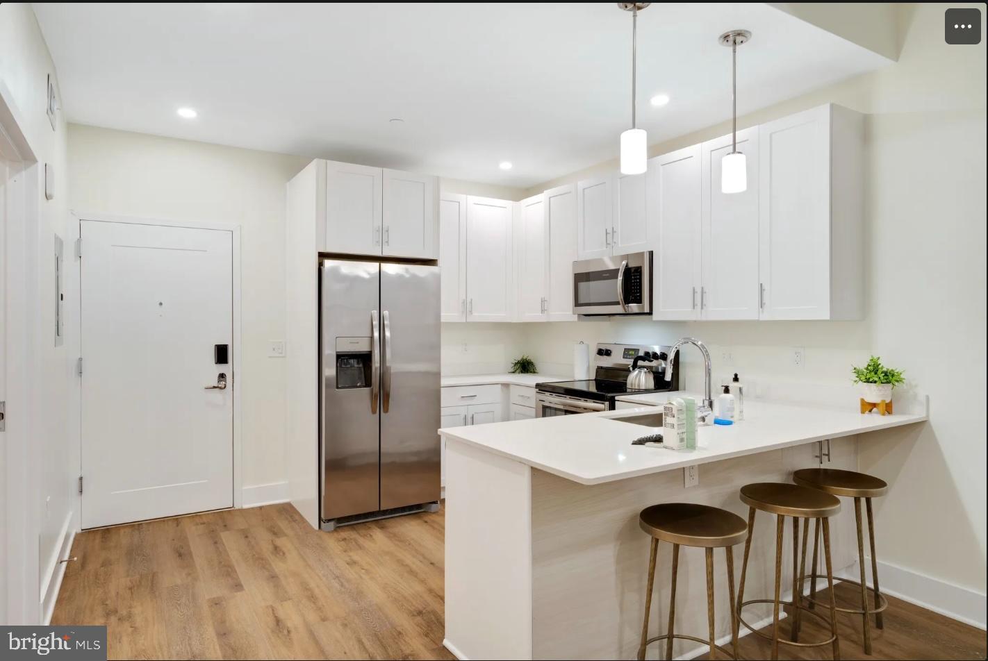 150 South Independence Mall West, Unit 1013 Philadelphia, PA 19106 - Photo 7 of 16 a kitchen with a sink stainless steel appliances and refrigerator