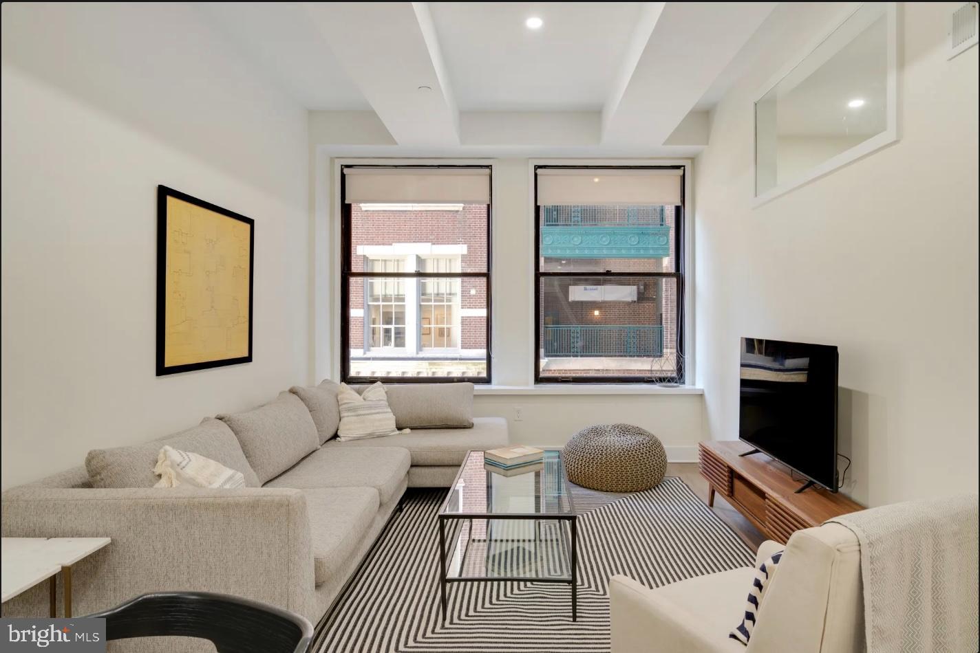 150 South Independence Mall West, Unit 1013 Philadelphia, PA 19106 - Photo 9 of 16 a living room with furniture and a flat screen tv