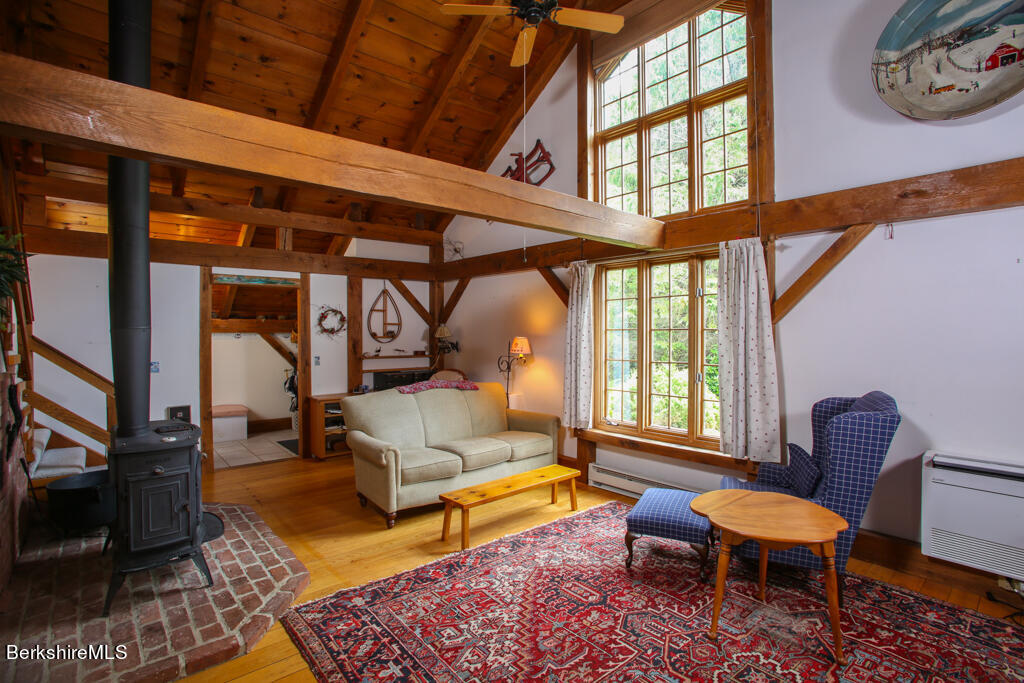 544 Tunnel Road Rowe, MA 01367 - Photo 14 of 32 a living room with furniture a rug and a large window